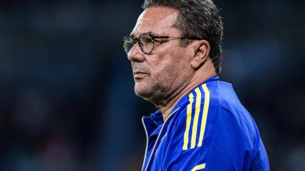 Corinthians contrata técnico Vanderlei Luxemburgo para 2023 - Vanderlei Luxemburgo na área técnica do Cruzeiro, em jogo do time mineiro. A câmera foca nele, que usa um agasalho azul com listras amarelas nos ombros. Vanderlei tem o semblante sério, usa óculos e está atento ao campo de jogo